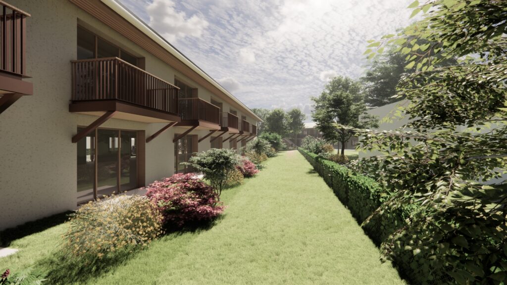 Un plan 3D détaillé du projet d'habitat inclusif et intergénérationnel à Villars-Lès-Dombes : un grand espace vert à côté du bâtiment comportant des sections avec balcons et grandes fenêtres.